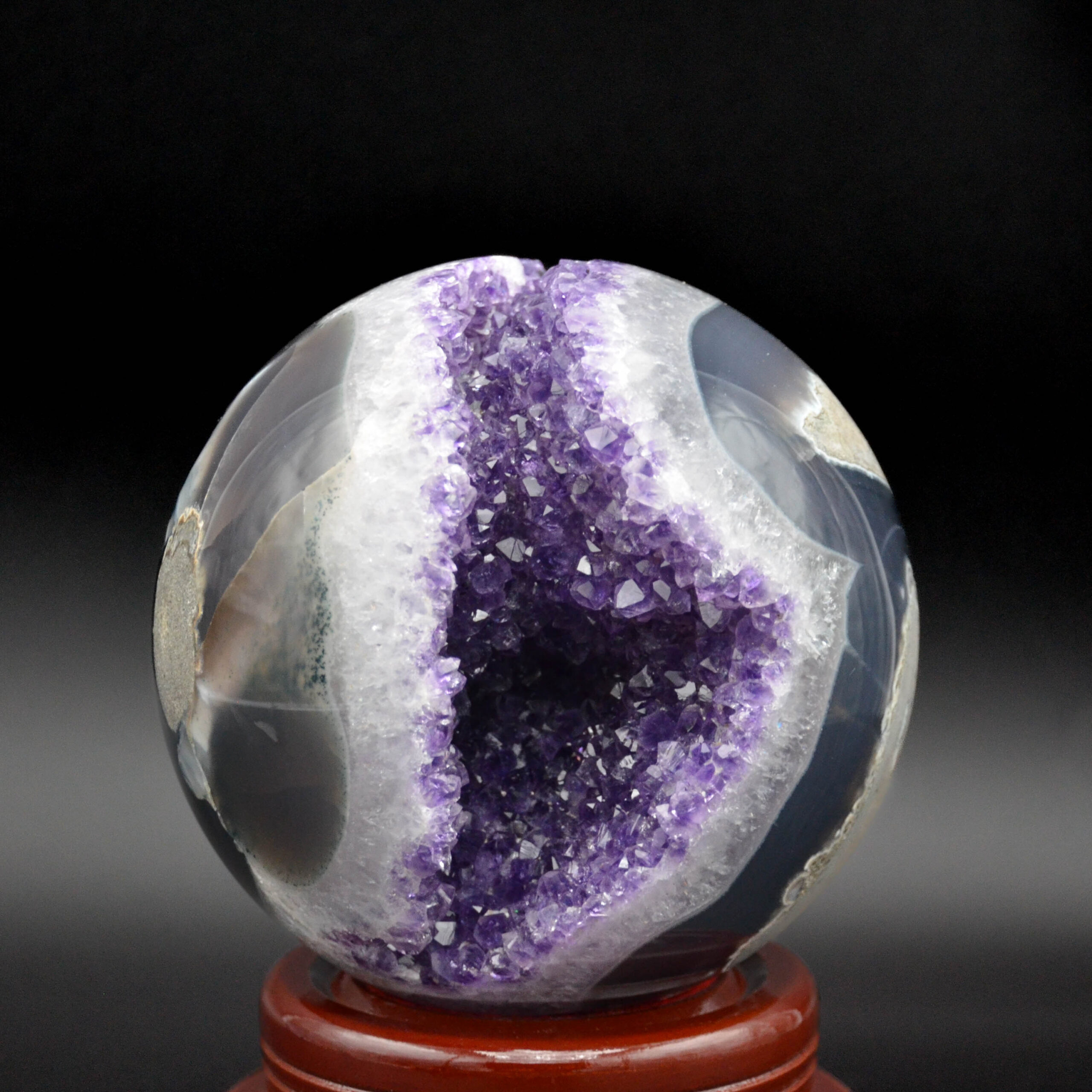 Magnificent amethyst in an agate geode from Uruguay on its wooden